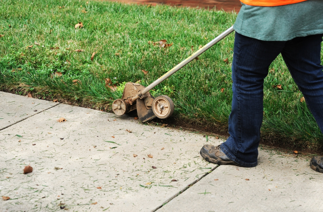 Lawn care professional mowing a lawn