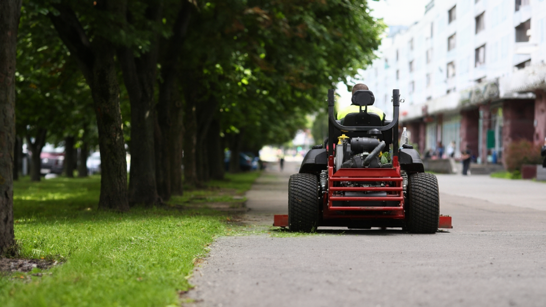 Lawn care professional mowing a lawn